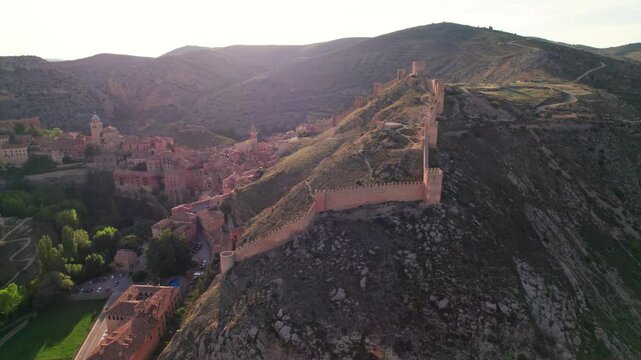 Discover Albarrac&iacute;n from above in spectacular 4K: fly over its river walkway, its iconic walkways and the landscapes surrounding this picturesque Aragonese village full of history.