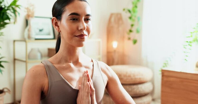 Yoga, woman and meditation with namaste in home for holistic wellness, spiritual zen and mindfulness with plants. Yogi, girl and praying hands on floor of living room with eyes closed and peaceful