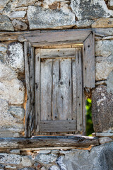 Old Wooden Window in the Wall of an Old Stone Building