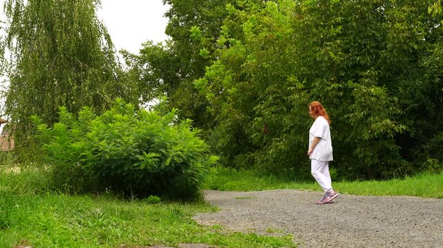 Senior woman walks relaxing outdoor on nature
