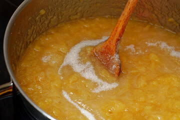 Apples and sugar in cooking pot preparing preparing