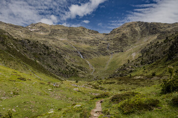 Natural park of valley Comapedrosa at summer with rivers and waterfalls, snow in the mountains, Andorra