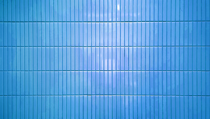 close up image of blue ceramic clay wall tiles use as background with blank space for design. abstract interior wall finishing material. tiles background. subway brick in vertical pattern.