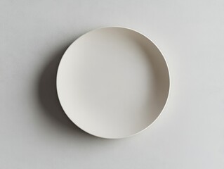 Minimalist white plate on a textured surface