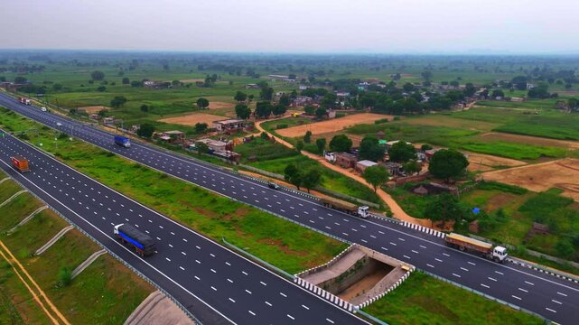Modern roadways in Rajasthan run through the middle of greenery, surrounded by field