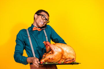 Portrait of elegant young man roasted thanksgiving day turkey talk phone empty space isolated on...