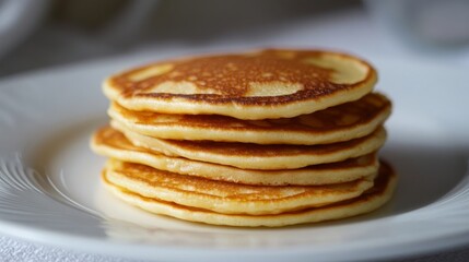 Blini on plate, side view.