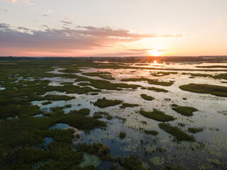 Aerial panoramic sunset sunrise scene at swamps and wetlands of Big Creek National Wildlife Area near Long Point Provincial Park, Lake Erie shore.