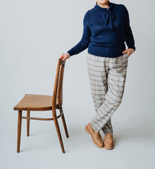This is an elegant casual outfit featuring a cozy sweater paired with stylish checked trousers, all...