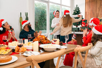 Joyful Christmas Dinner Celebration, Family Friends Gather Around the Table Meal, Enjoying Delicious Food and Drinks in Beautifully Decorated Home, Creating Happy Memories During Holiday Event