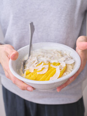 Overnight oats with mango and coconut topping. Fitness healthy breakfast in a bowl