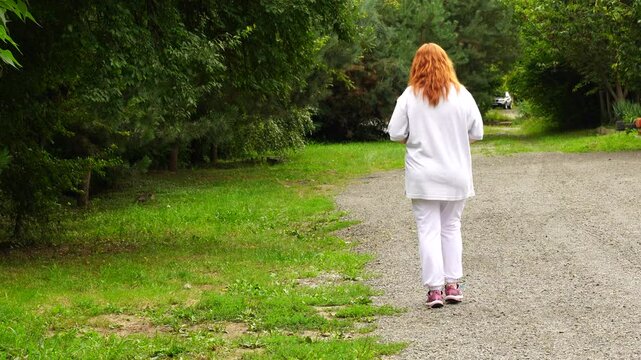 Senior woman walks relaxing outdoor on nature