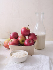 Ingredients for making overnight oats or a porridge bowl. Grains, fruits, berries and dairy products. White background