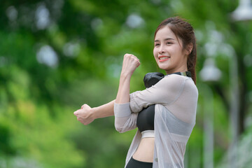 Smiling  Asian woman doing sport exercises running jogging in morning park, skinny fit in sports wear outfit leggings. fitness woman running around in the park.