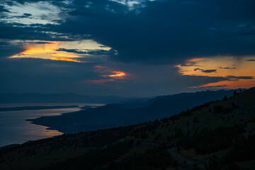 Sunset behind clouds over the Croatian Adriatic coast.