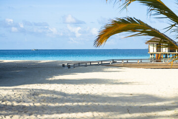 Stilt house with wooden walkway to the beach in Maldives