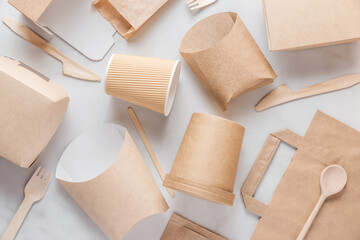 Eco-friendly, biodegradable disposable food packaging and cutlery made of paper and wood. Cups, bags, cutlery and containers for sustainable and environmentally conscious food service. Flat lay