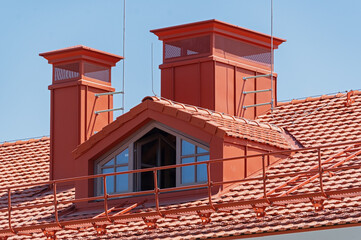 House with a pipe  and attic window on a roof