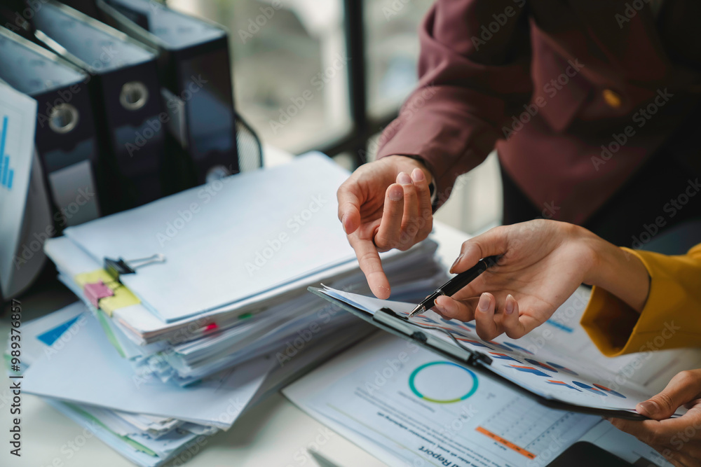 Poster business people having a conversation and analyzing financial documents while pointing at charts on 