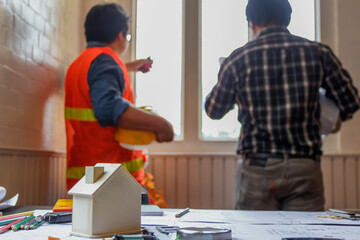 Work equipment placed on desk in office of team of engineers and architects design large construction project to meet needs of investors and check feasibility of project by an architect with expertise