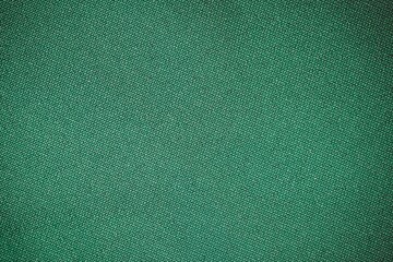 High-quality texture of rich royal green fabric with a soft and luxurious feel. This deep green material features a smooth, perfect for backgrounds, textiles, wallpapers