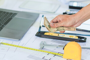 Engineers and Foreman are calculating workers' expenses and overtime to pay workers compensation...