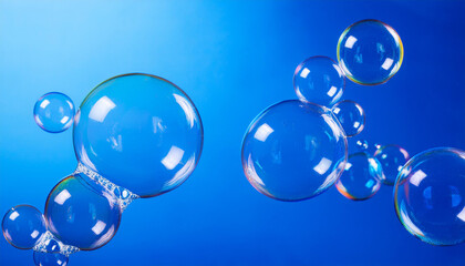 Shimmering soap bubbles on vibrant blue background. Glowing shades and fluid patterns. Close-up.