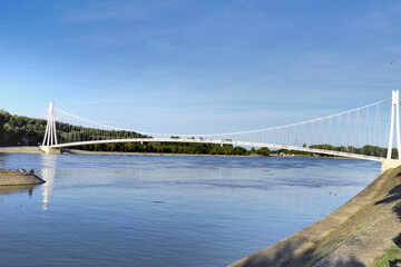 Obraz premium The Drava River flows under the suspension bridge in the Croatian city of Osijek