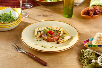 Elegant Plated Appetizer with Grilled Bread and Artistic Presentation on Rustic Wooden Table
