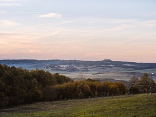 Obraz premium Scenic Countryside Landscape with Autumn Forest and Rolling Hills