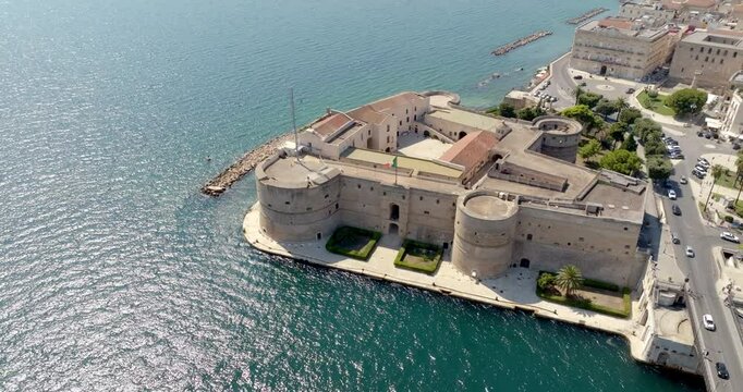Aerial view of the Aragonese castle, officially called Castel San Angelo, in the historic center of Taranto, Puglia, Italy. It has a quadrangular plan and a large central courtyard.
