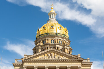 Fototapeta premium The Iowa state Capitol building on a hot late summer day with blue skies and clouds. Des Moines, Iowa, USA.