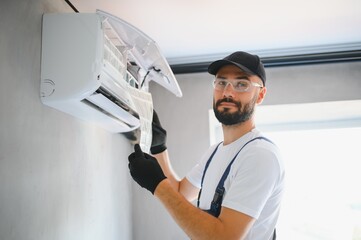 Repairman fix air conditioning systems, Male technicians service for repair and maintenance of air...