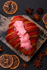 Crispy fresh red croissant with cream and strawberries