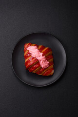 Crispy fresh red croissant with cream and strawberries