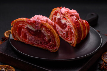 Crispy fresh red croissant with cream and strawberries