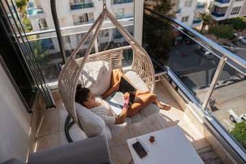 I relax on a stylish balcony hammock, sipping coffee and reading my favorite book or magazine