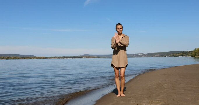 Photo posing - young beautiful girl shows correct poses for a photo on the beach