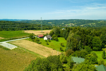 A stunning aerial view of lush green fields, quaint houses, and a picturesque landscape under a...