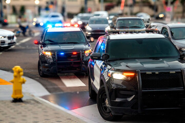 Two police cars with emergency lights on stopped in urban traffic © F Armstrong Photo