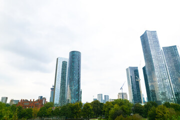 Obraz premium Commercial area, highrise tower office building in Deansgate Manchester, overcast day, aerial view