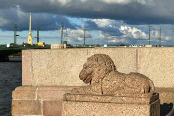 Stone old lion on Makarov Embankment of Malaya Neva River. St. Petersburg, Russia