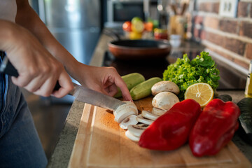 Young woman preparing fresh vegetables in a modern kitchen
