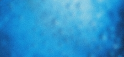 Blurred background of water drops on blue background with grainy texture
