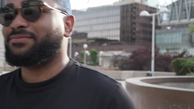 Confident african american man with sunglasses and tablet walking in a modern building environment. Lifestyle and successful success life. Urban street style concept.MOV