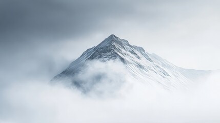 Majestic Snowy Mountain Peak Emerging from the Clouds