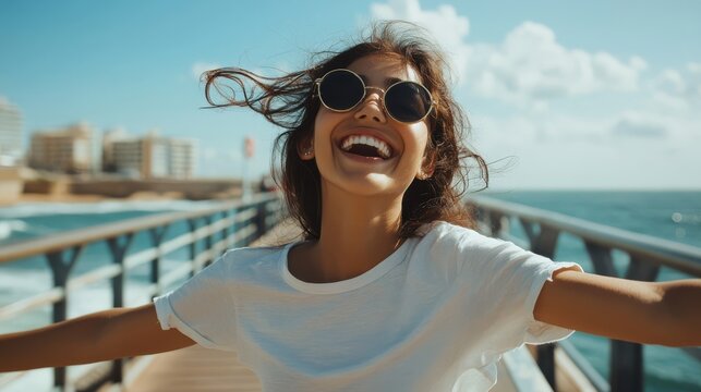 A carefree teenaged skater girl smiles widely as she glides along the boardwalk - Powered by Adobe