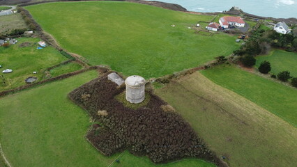 Aerial view of historic stone tower near coastline
