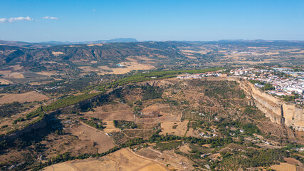 Aerial photo from drone to Puente Nuevo (The New Bridge)  over Guadalevin River in Ronda medieval town sunset. Ronda, Andalusia, Spain.