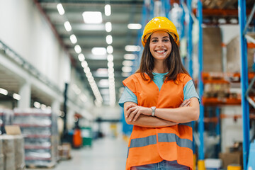 Woman standing confidently arms crossed in large warehouse.